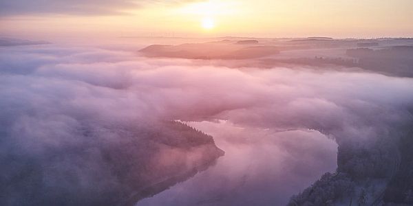 mist rising up from a river at dawn