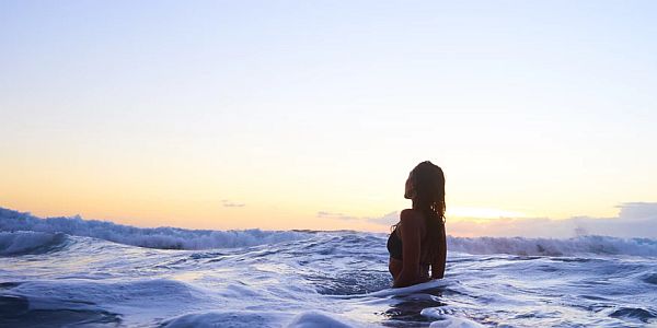 silhouette of a woman standing in the sea
