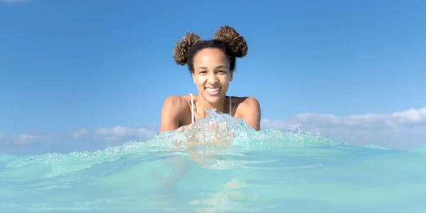 smiling woman swimming in the ocean